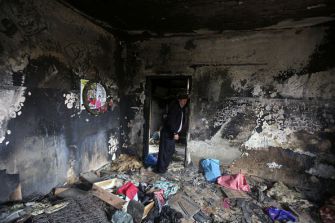 Terrorist Victims: A relative stands inside the burnt-out home of Saad Dawabsha, who was killed alongside his infant and wife when Jewish extremists firebombed their house in the West Bank village of Duma last July.